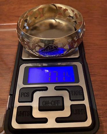 Серебряные браслеты: Серебряный браслет с позолотой с ажурным орнаментом. В центре браслета — 9