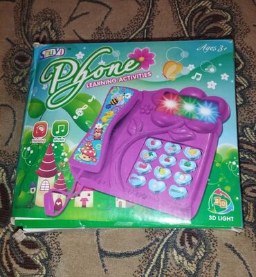 oyuncaq tozsoran: Oyuncaq ev telefonu satılır. Səsli ve ışıqlıdır, mahnı ve ingiliscə