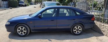 электромобиль neta: Синий хэтчбек Mazda 323F с четырьмя дверьми, подходящий для