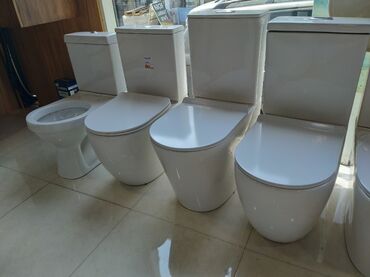 Mətbəx kranları: Ağ rəngli keramika unitaz, yumru formalı oturacaqla tamamlanır