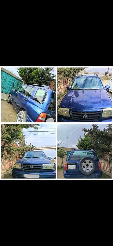 man tir: Suzuki Grand Vitara, mavi rəng, 5 qapılı SUV. Xüsusiyyətlər: - Kuzov — 1