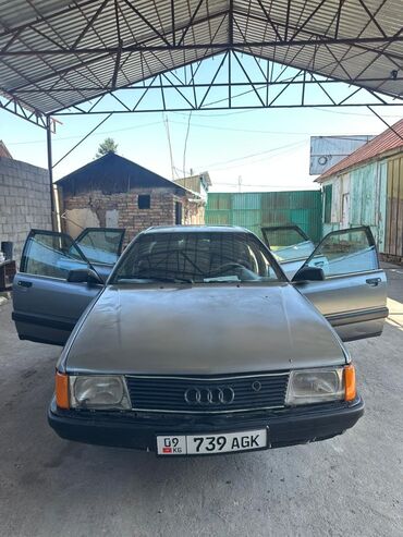 машина базар ош телеграм: Седан Audi 100 серого цвета с классическим дизайном. Автомобиль