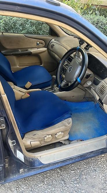 ua 705: Mazda Familia: 2002 г., Автомат, Бензин, Седан — 1