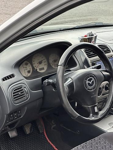 пороги демио: Mazda 323: 2001 г., 1.6 л, Механика, Бензин, Хэтчбэк — 7
