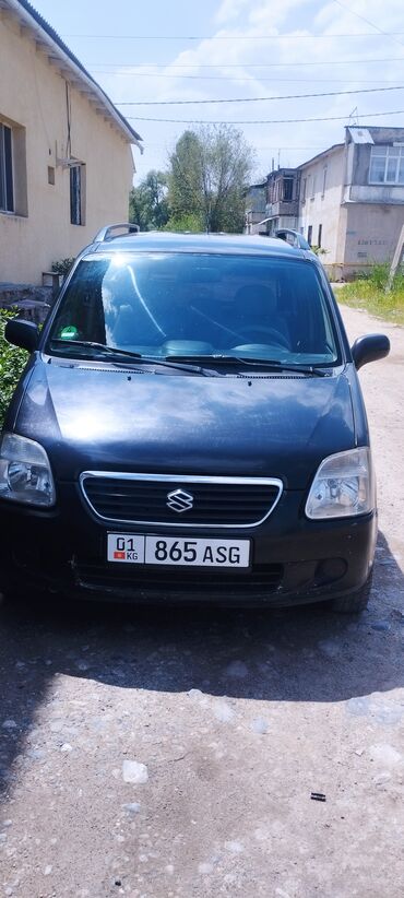 Suzuki: Автомобиль Suzuki Wagon R в черном цвете. Оснащен рейлингами на крыше