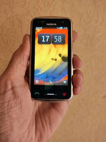 knopkali telefonlar qiymetleri: Nokia C6-01, цвет - Серебристый, Сенсорный