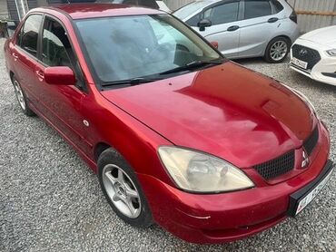 запчасти на митсубиси лансер 9: Седан Mitsubishi Lancer красного цвета, отличающийся элегантным и