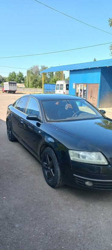 Audi: Автомобиль Audi A6 черного цвета с тонированными стеклами. Оснащен