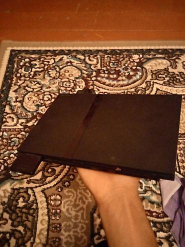 Real alıcıya 55mPlayStation 2 Slim oyun konsolu. Komplektə şəkildə