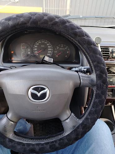 обшивка мазда: Салон автомобиля Mazda левый рулём,светлая тканевая отделка.2 объём — 2