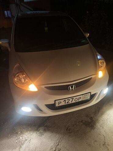 купить авто недорого: Белый хэтчбек Honda Fit с пятью дверями, оснащенный литыми дисками и