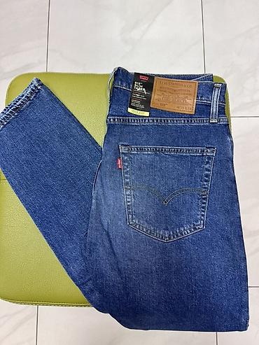 Джинсы: Levi’s 512 Slim Taper — мужские джинсы с заужением к низу. - Линия — 1