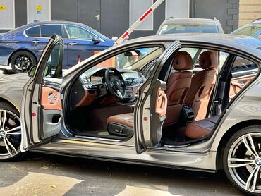 bmw e30: Gümüşü rəngdə olan BMW 5 Seriyası sedanı. Avtomobil dəri interyerə və