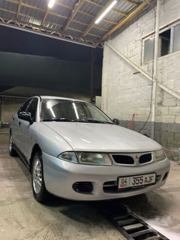 Передние фары: Mitsubishi Carisma: 1998 г., 1.8 л, Автомат, Бензин, Седан