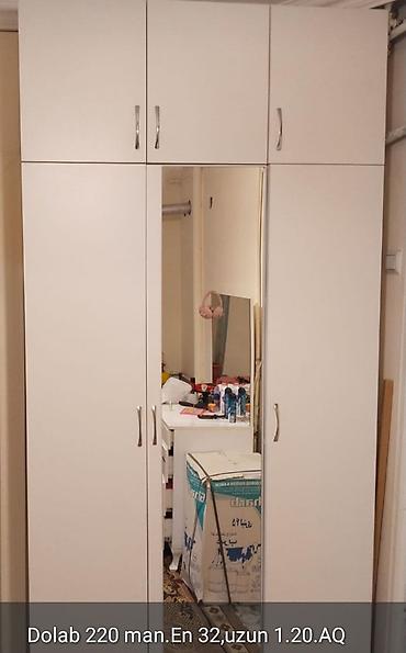 Ağ rəngdə üç qapılı şkaf, üst hissədə üç ayrıca dolab bölməsi ilə