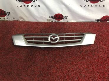 Другие автозапчасти: Решетка Mazda Demio DW3W 1300 2001 (б/у) КУЗОВНЫЕ ДЕТАЛИ - #капот