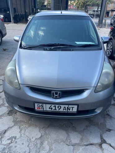 купить передние тормозные диски: Хэтчбек Honda Fit серебристого цвета, представленный на фотографиях