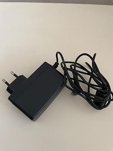 modem adapter: LG orijinal “Switching Adapter” enerji bloku LG televizorunun üstündə — 3