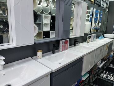 hamam ucun moydadirlar: Ağ rəngli keramika lavabo və boz rəngli rəfli şkafdan ibarət hamam