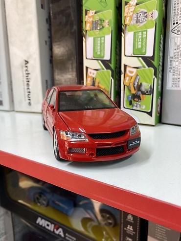 митси бутси: Коллекционная модель автомобиля Mitsubishi Lancer Evolution в красном — 1