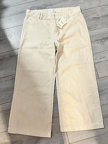 calcedonia helanke: Široke pantalone u krem/bež boji. Model sa visokim strukom i ravnim — 1