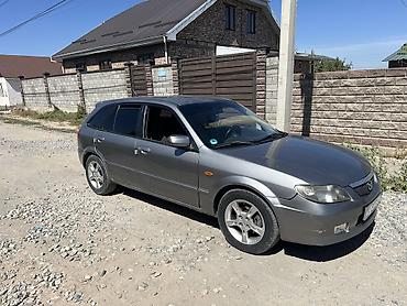 руль левый: Mazda 323: 2002 г., Механика, Бензин, Хэтчбэк — 2