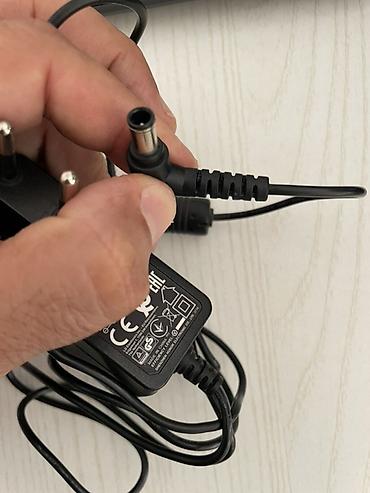 modem adapter: LG orijinal “Switching Adapter” enerji bloku LG televizorunun üstündə — 4