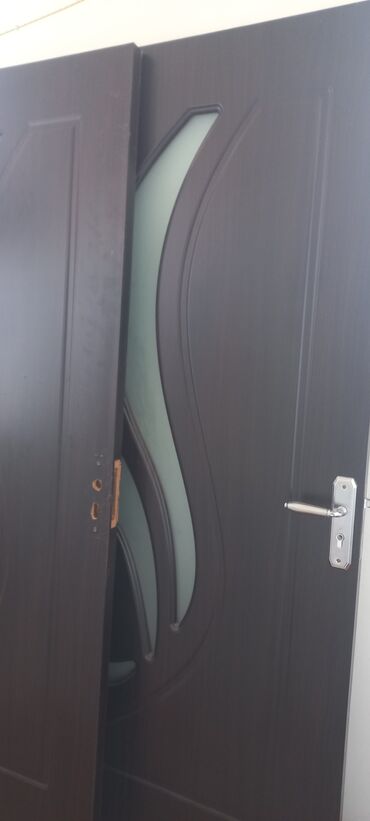 Otaq qapıları: Tünd qəhvəyi rəngdə, şüşə dekorlu daxili qapı. Qapının üzərində metal