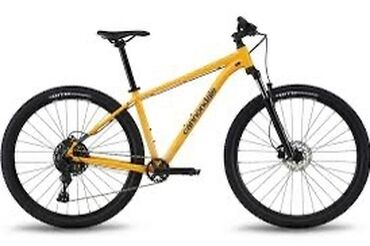 моторчик для велосипеда: Горный велосипед Cannondale яркого жёлтого цвета. Оснащён передней