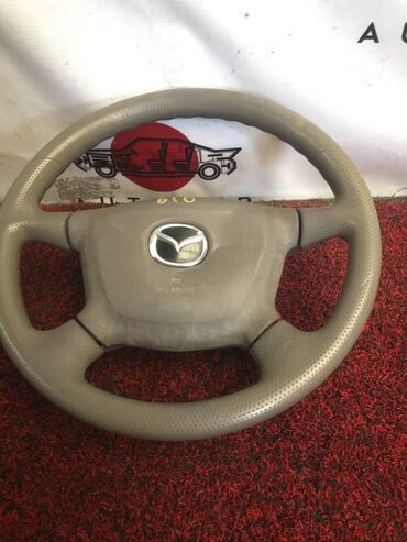 Другие автозапчасти: Руль с аирбагом Mazda Familia BJ5W 1500 2000 (б/у) САЛОННЫЕ ДЕТАЛИ -