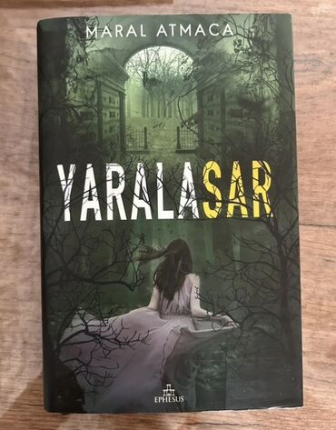 Maral Atmaca tərəfindən yazılmış "Yaralasar" kitabı, ön qapağında