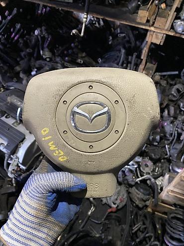 Подушка безопасности водителя (Airbag) в рулевое колесо Mazda. -