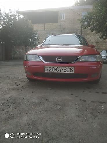 opel 1 3: Opel Astra Vectra (ünvan nömrəsi görünür), qırmızı rəngli universal — 1