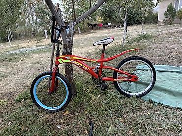 Детский велосипед в стиле BMX, красного цвета. Особенности: - прочная
