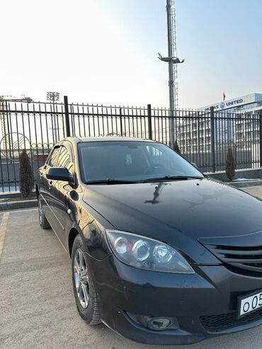 ключ мазда: Автомобиль Mazda 3 черного цвета, седан, с российскими номерными