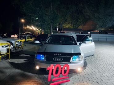 audi a6 автомобиль: Серебристый седан Audi A6, оснащенный синими фарами и черным капотом