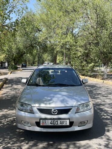 купить новый мотоцикл в бишкеке: Серебристый хэтчбек Mazda Familia, предлагающий практичность и