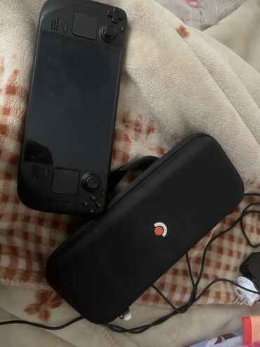 модем куплю: Портативная игровая приставка Valve Steam Deck Oled в черном цвете