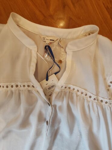 Futbolka və maykalar: Ağ rəngli, qısaqol qadın bluzası. Bluzanın yaxası V formalıdır və — 2