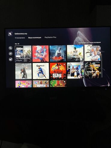 чысы телефон: На экране телевизора отображена библиотека игр на PlayStation 5. Видны
