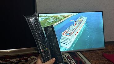 Телевизоры: Телевизор Smart TV, диагональ около 40–43". Тонкие рамки, нижняя — 6