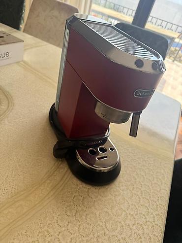 delonghi: DeLonghi markalı qırmızı espresso qəhvə maşını. Bu kompakt model evdə — 1