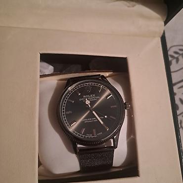 swatch black coat: Rolex Oyster Perpetual – qara siferblatlı, klassik analoq qol saatı — 1