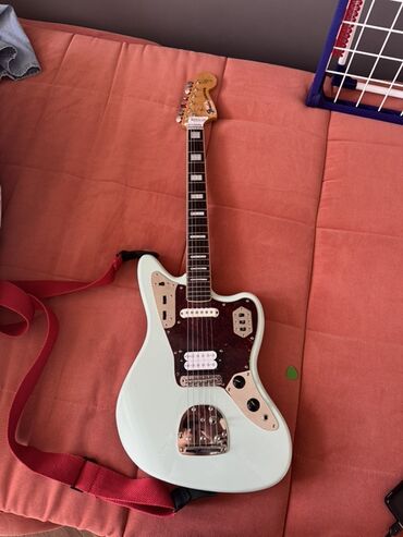 Гитары: Электрогитара Squier Jaguar с корпусом светло-зеленого цвета . Модель