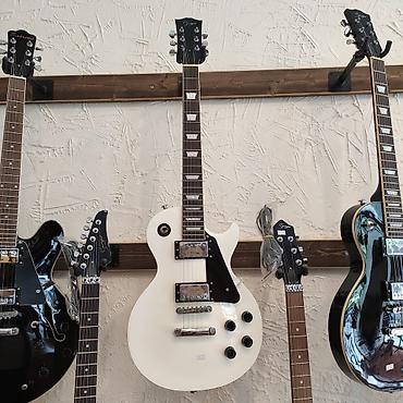 Gitaralar: Elektro-gitara Smiger L-G9 WH Simlərin sayı: 6 Üst: Ağcaqayın Qol: Gül — 1