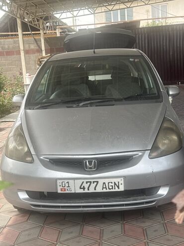 авто фит: Автомобиль Honda Fit серебристого цвета. На крыше установлен черный
