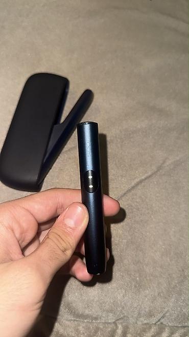 meduza qelyan: IQOS elektron tütün cihazı və qutusu. Tünd rəngli, kompakt və — 1