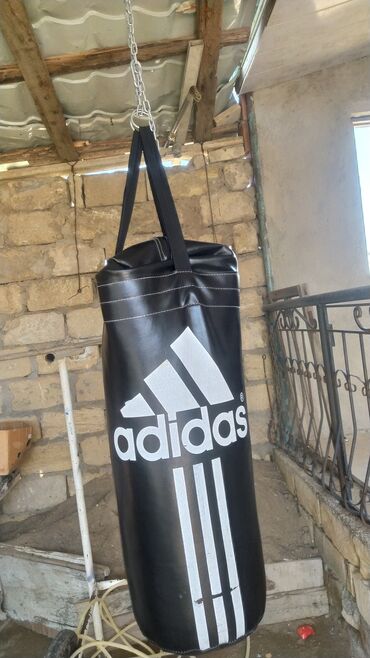 Boks kisələri: Qara rəngdə, üzərində böyük ağ Adidas loqosu olan boks kisəsi. Zəncir