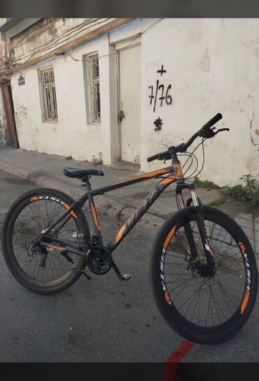 Tünd boz rəngli, narıncı vurğulara malik bu dağ velosipedi müxtəlif