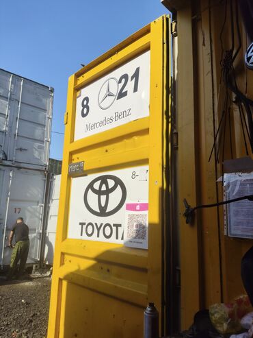 Mercedes-Benz: Желтая дверь контейнера с логотипами Mercedes-Benz и Toyota